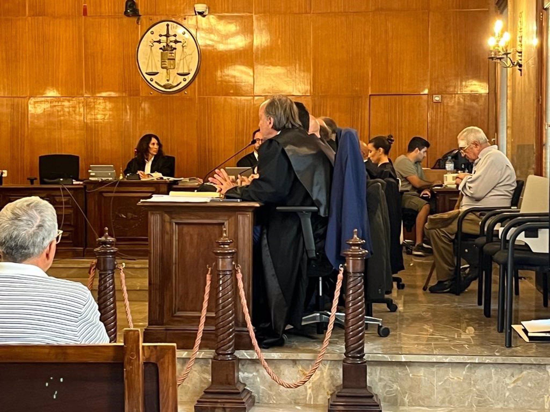 A la derecha, sentado tras los abogados y el fiscal, el anciano que mató a un ladrón que asaltó su casa en Porreres en 2018. A la izquierda, en el banquillo, uno de los acusados por participar en el robo. - EUROPA PRESS - Archivo