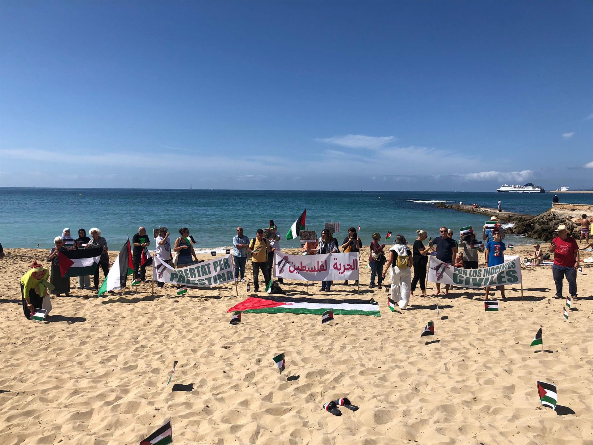 Acto de 'plantada' de banderas palestinas en una playa en Palma para reivindicar sanciones a Israel e investigar crímenes de guerra en Gaza - MALLORCA PER PALESTINA